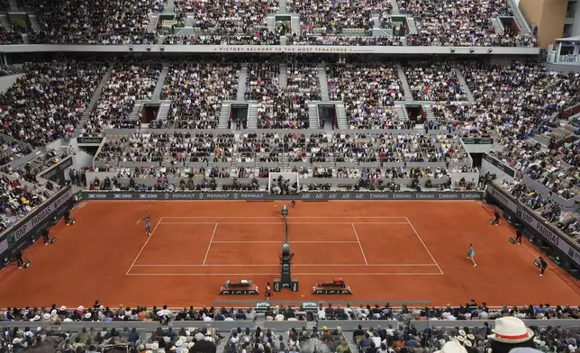 United States' Coco Gauff serves to Aryna Sabalenka of Belarus during the final match of the French Tennis Open at the Roland-Garros in Paris, Saturday, June 7, 2025. (AP Photo/Lindsey Wasson)