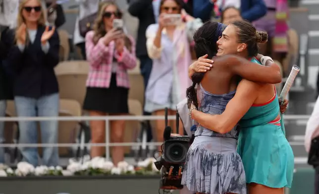 Winner Coco Gauff of the U.S., left, and Aryna Sabalenka of Belarus hug after their final match of the French Tennis Open at the Roland-Garros stadium in Paris, Saturday, June 7, 2025. (AP Photo/Aurelien Morissard)