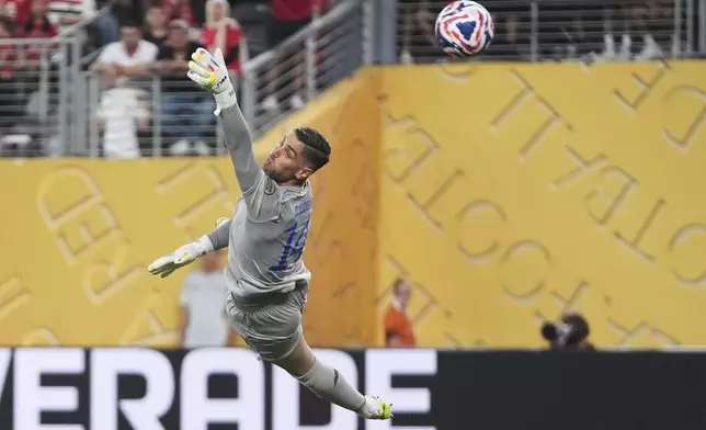 Porto's goalkeeper Claudio Ramos is airborne as he fails to stop a goal from Al Ahly's Mohamed Ali Ben Romdhane during the Club World Cup Group A soccer match between FC Porto and Al Ahly in East Rutherford, N.J., Monday, June 23, 2025. (AP Photo/Frank Franklin II)