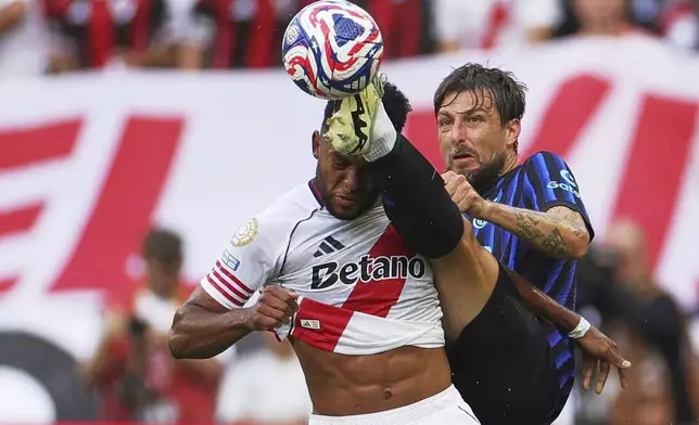 Inter Milan's Francesco Acerbi kicks at the ball as River Plate's Miguel Borja, left, reacts during the Club World Cup Group E soccer match between Inter Milan and River Plate in Seattle, Wednesday, June 25, 2025. (AP Photo/Ryan Sun)