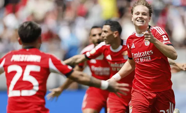Benfica's Andreas Schjelderup and Gianluca Prestianni celebrate after scoring during the Club World Cup Group C soccer match between Benfica and Bayern Munich in Charlotte, N.C., Tuesday, June 24, 2025. (AP Photo/Nell Redmond)