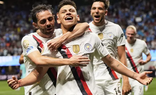 Manchester City's Claudio Echeverri is congratulated by teammates after scoring his team's second goal during the Club World Cup Group G soccer match between Manchester City and Al Ain in Atlanta, Sunday, June 22, 2025. (AP Photo/Mike Stewart)