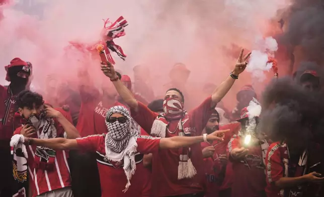 Wydad supporters light torches during the Club World Cup Group G soccer match between Juventus and Wydad AC in Philadelphia, Sunday, June 22, 2025. (AP Photo/Chris Szagola)