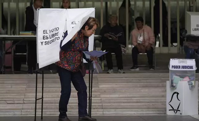 A voter leaves after casting her ballot in Mexico's first judicial elections, in Mexico City, Sunday, June 1, 2025. (AP Photo/Marco Ugarte)