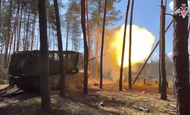 In this photo, taken from video released by Russian Defense Ministry Press Service on Monday, June 9, 2025, a Russian T-90 tank fires towards a Ukrainian position on an undisclosed location in Ukraine. (Russian Defense Ministry Press Service via AP)