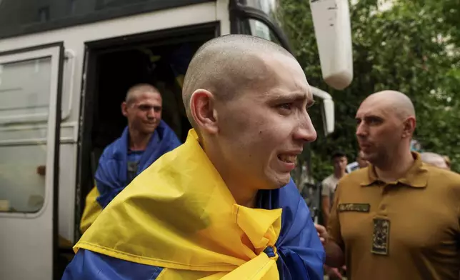 An Ukrainian soldier reacts after returning from captivity after a POWs exchange between Russia and Ukraine, in Chernyhiv region, Ukraine, Monday, June 9, 2025. (AP Photo/Evgeniy Maloletka)