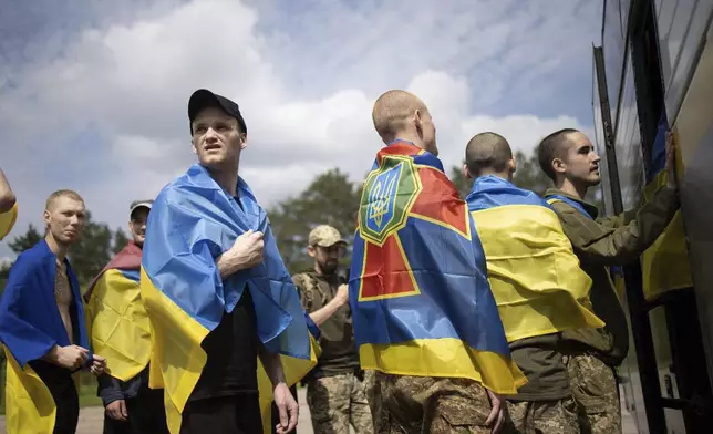 In this photo provided by the Ukrainian Presidential Press Office, Ukrainian soldiers react after returning from captivity during a prisoners' exchange between Russia and Ukraine, in Chernyhiv region, Ukraine, Monday, June 9, 2025. (Ukrainian Presidential Press Office via AP)