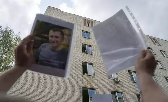 An Ukrainian soldier looks out from a window after returning from captivity after a POWs exchange between Russia and Ukraine, in Chernyhiv region, Ukraine, Monday, June 9, 2025. (AP Photo/Evgeniy Maloletka)