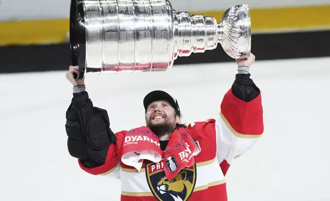 Florida Panthers goalie Sergei Bobrovsky (72) raises the Stanley Cup after defeating the Edmonton Oilers in Game 6 of the NHL hockey Stanley Cup Final in Sunrise, Fla., Tuesday, June 17, 2025. (Nathan Denette/The Canadian Press via AP)