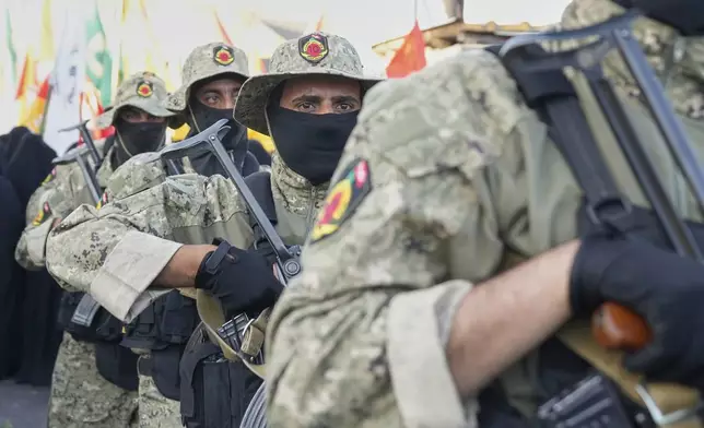 Members from the Popular Mobilization Forces attend the funeral of commander Haider al-Moussawi from Kataeb Sayyed Al-Shuhada who was killed with Hussein Khalil, a former aide to the late Hezbollah's former leader Hassan Nasrallah an Israeli airstrike inside Iran, in Baghdad, Iraq, Sunday, June 22, 2025. (AP Photo/Hadi Mizban)