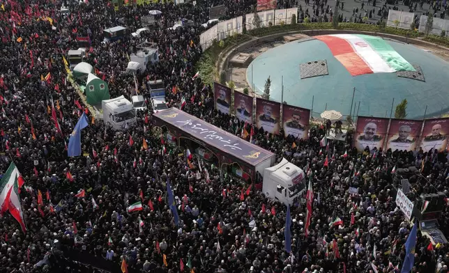 Mourners attend the funeral ceremony of the Iranian armed forces generals, nuclear scientists and their family members who were killed in Israeli strikes, at Islamic Revolution Square (Enghelab Square) square, in Tehran, Iran, Saturday, June 28, 2025. (AP Photo/Vahid Salemi)
