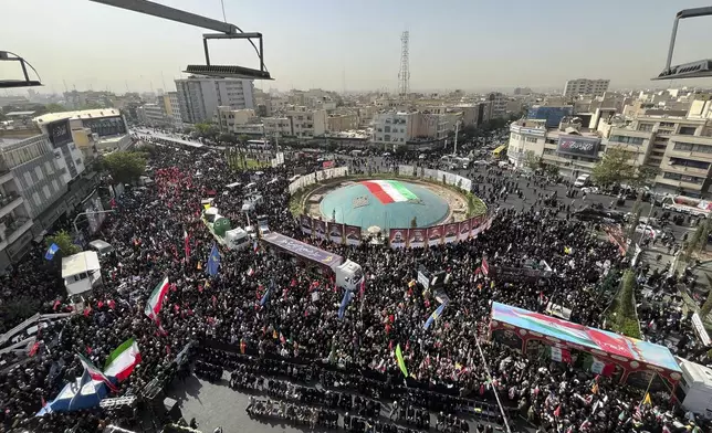 Mourners gather in Islamic Revolution Square (Enghelab Square) to attend the funeral ceremony of the Iranian army generals, nuclear scientists and their family members who were killed in Israeli strikes, during a funeral ceremony in Tehran. Iran, Saturday, June 28, 2025. (AP Photo/Vahid Salemi)