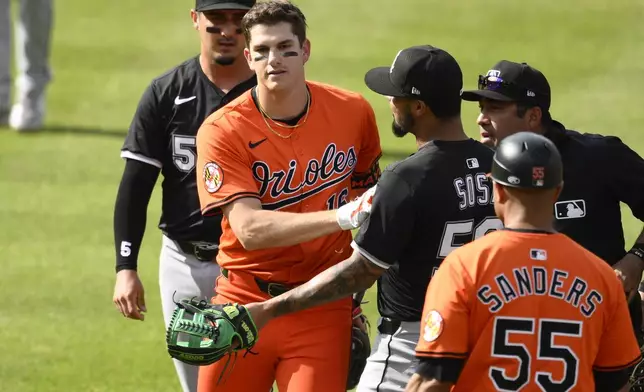 Baltimore Orioles' Coby Mayo, front left, pushes Chicago White Sox second baseman Lenyn Sosa (50) after he was tagged out in a rundown during the fourth inning of a baseball game, Saturday, May 31, 2025, in Baltimore. (AP Photo/Nick Wass)
