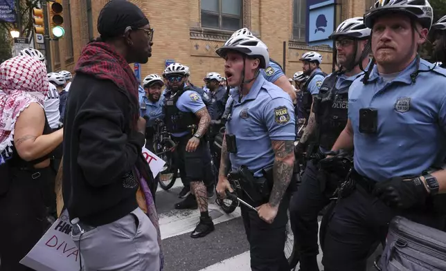 Police officers confront protestors, Saturday, June 14, 2025, in Philadelphia. (AP Photo/Yuki Iwamura)