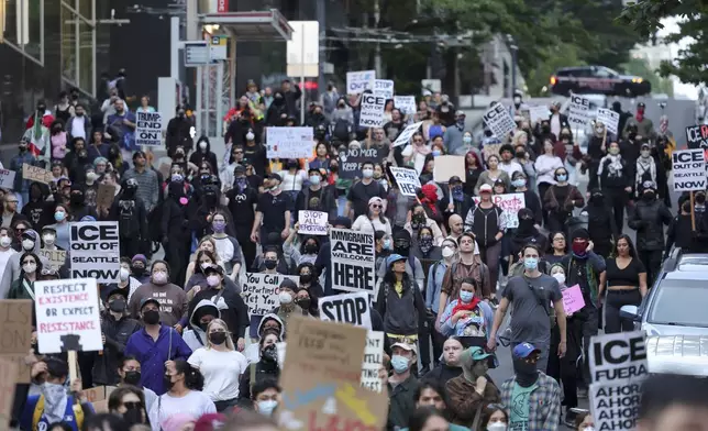 EDS NOTE: OBSCENITY - Protestors march during a protest against federal immigration arrests, Wednesday, June 11, 2025, in Seattle. (AP Photo/Ryan Sun)