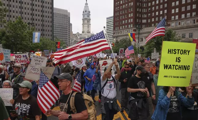 Demonstrators march during the "No Kings" protest, Saturday, June 14, 2025, in Philadelphia. (AP Photo/Yuki Iwamura)
