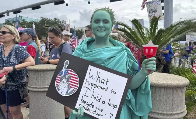 Anna Marie Shealy dressed as Lady Liberty for the “No Kings” protest in Tallahassee, Fla. on June 14, 2025. (AP Photo/Kate Payne)