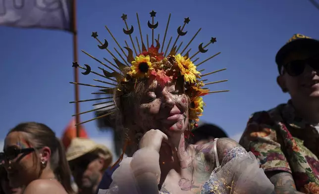 Members of the crowd watch Burning Spear perform on the Pyramid stage during the Glastonbury Festival at Worthy Farm in Somerset, England, on Friday June 27, 2025. (Yui Mok/PA via AP)