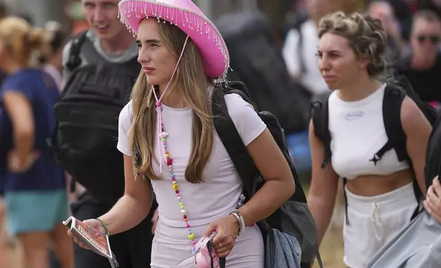 Festival goers arrive at the Glastonbury Festival in Worthy Farm, Somerset, England, Wednesday, June 25, 2025. (Scott A Garfitt/Invision/AP)