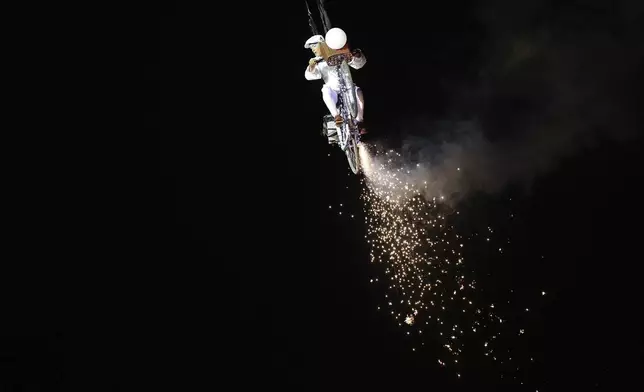 A circus performer during the Glastonbury Festival at Worthy Farm, in Somerset, England, Wednesday, June 25, 2025. (Scott A Garfitt/Invision/AP)