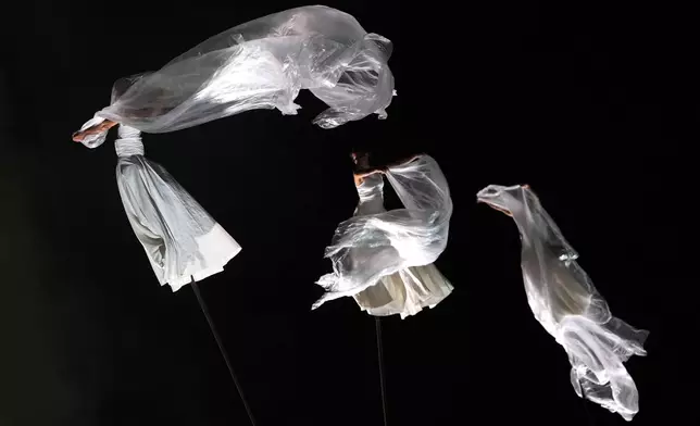 Circus performers during the Glastonbury Festival in Worthy Farm, in Somerset, England, Wednesday, June 25, 2025. (Scott A Garfitt/Invision/AP)