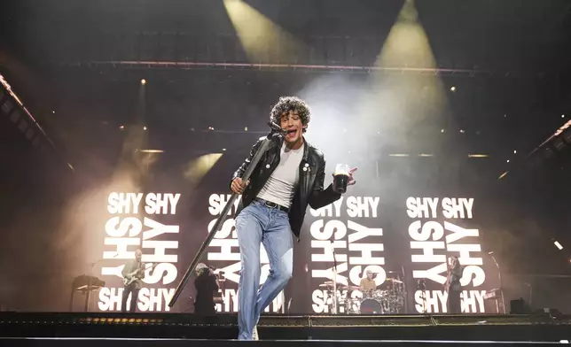 Matty Healy of The 1975 performs during the Glastonbury Festival in Worthy Farm, Somerset, England, Friday, June 27, 2025. (Scott A Garfitt/Invision/AP)