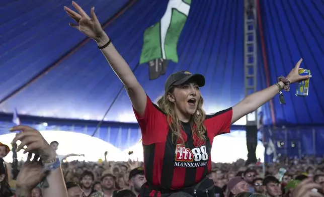 Festivalgoers watch Myles Smith perform during the Glastonbury Festival in Worthy Farm, Somerset, England, Friday, June 27, 2025. (Scott A Garfitt/Invision/AP)