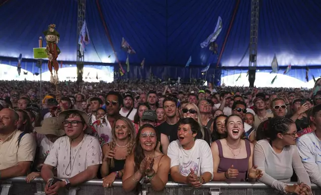Festivalgoers watch Myles Smith perform during the Glastonbury Festival in Worthy Farm, Somerset, England, Friday, June 27, 2025. (Scott A Garfitt/Invision/AP)