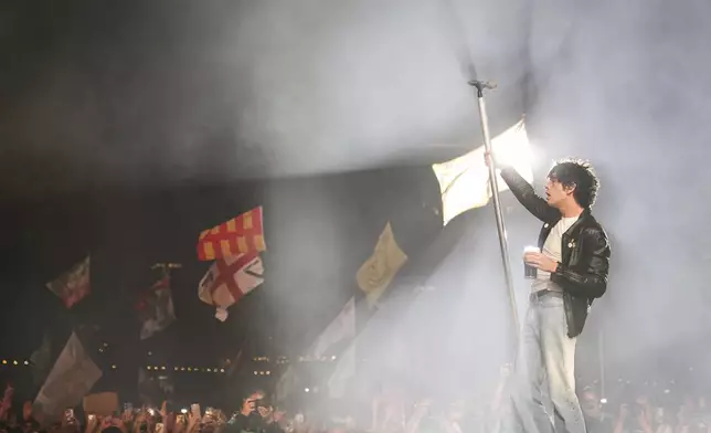 Matty Healy of The 1975 performs during the Glastonbury Festival in Worthy Farm, Somerset, England, Friday, June 27, 2025. (Scott A Garfitt/Invision/AP)