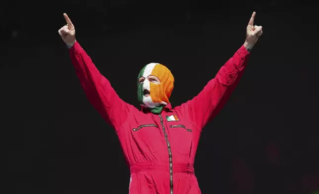 J. J. O Dochartaigh from the hip hop trio Kneecap performs during the Glastonbury Festival in Worthy Farm, Somerset, England, Saturday, June 28, 2025. (Scott A Garfitt/Invision/AP)