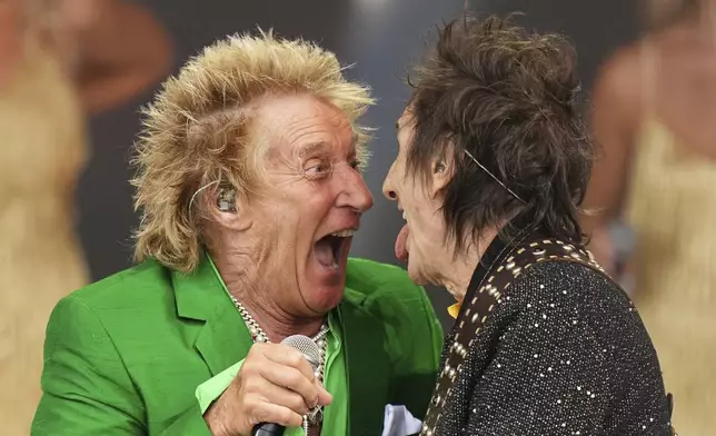 Rod Stewart, left, is joined on stage by Ronnie Wood during the Glastonbury Festival in Worthy Farm, Somerset, England, Sunday, June 29, 2025. (Scott A Garfitt/Invision/AP)