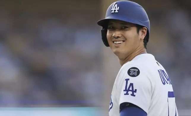 Los Angeles Dodgers designated hitter Shohei Ohtani reacts on base during the first inning of a baseball game against the Washington Nationals in Los Angeles, Friday, June 20, 2025. (AP Photo/Jessie Alcheh)