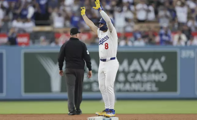 Los Angeles Dodgers' Enrique Hernández gestures after hitting a double during the third inning of a baseball game against the Washington Nationals in Los Angeles, Friday, June 20, 2025. (AP Photo/Jessie Alcheh)