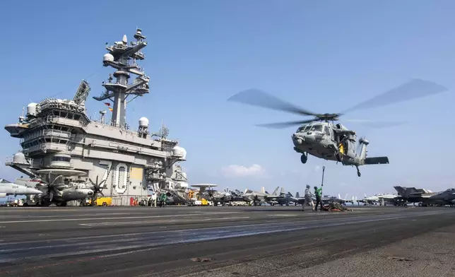FILE - This photograph released by the U.S. Navy shows a MH-60S Sea Hawk helicopter hovering over the USS Carl Vinson aircraft carrier while operating in the Middle East April 12, 2025. (Petty Officer 3rd Class Nathan Jordan/U.S. Navy via AP, File)