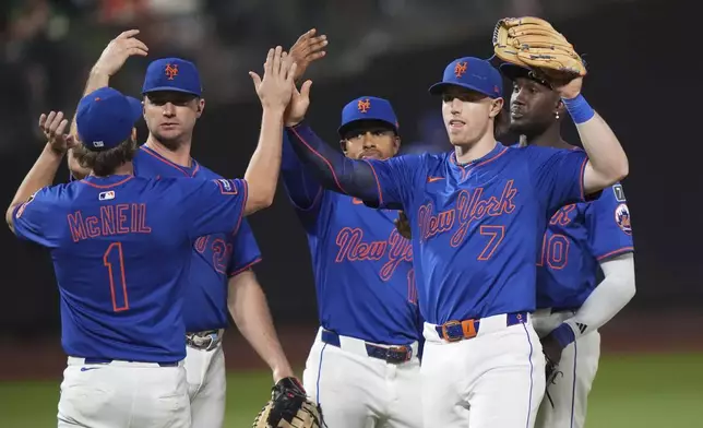 New York Mets' Jeff McNeil (1) and Brett Baty (7) celebrate with teammates after a baseball game against the Atlanta Braves Thursday, June 26, 2025, in New York. (AP Photo/Frank Franklin II)