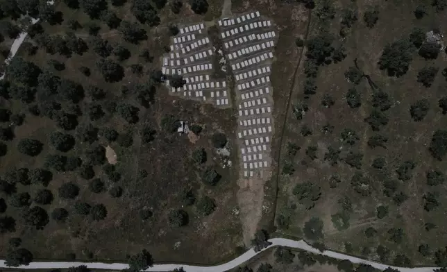 An aerial view of a refugee and migrant cemetery with graves of the people who lost their life in the Aegean Sea while crossing from Turkey to Greece, on Thursday, May 15, 2025. (AP Photo/Petros Giannakouris)