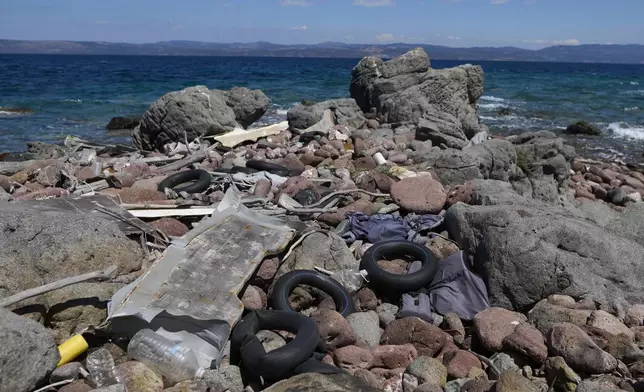 Abandoned dinghies, life vests and life jackets, used by refugees and migrants while crossing from Turkey to Greece, lie on the shore of Cape Korakas on May 14, 2025. (AP Photo/Petros Giannakouris)
