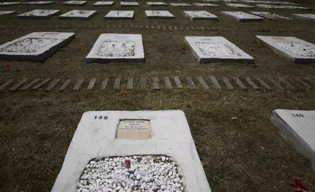 Graves at a cemetery for refugees and migrants who lost their lives while crossing the Aegean Sea from Turkey to Greece, on Thursday, May 15, 2025. (AP Photo/Petros Giannakouris)