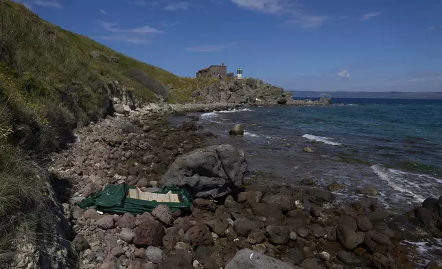 An abandoned dinghy used by refugees and migrants while crossing from Turkey to Greece is seen on cape Korakas, Wednesday, May 14, 2025. (AP Photo/Petros Giannakouris)