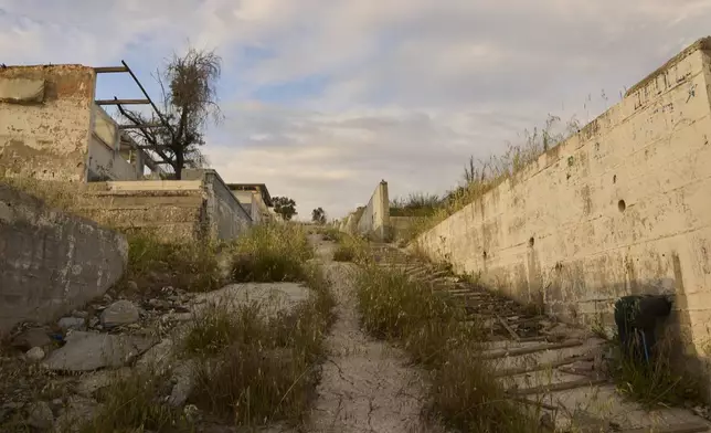The remains of the former Moria refugee camp, which was destroyed by a massive fire in Sept. 2020 after years of overcrowding and poor conditions, are seen on the island of Lesbos, Greece, Monday, May 12, 2025. (AP Photo/Petros Giannakouris)