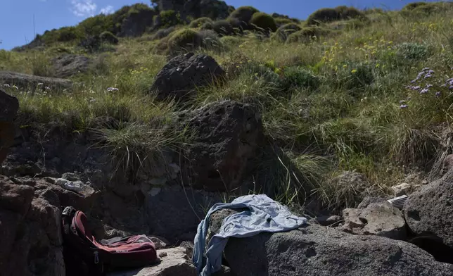 Abandoned clothing used by refugees and migrants while crossing from Turkey to Greece are seen on cape Korakas, Wednesday, May 14, 2025. (AP Photo/Petros Giannakouris)