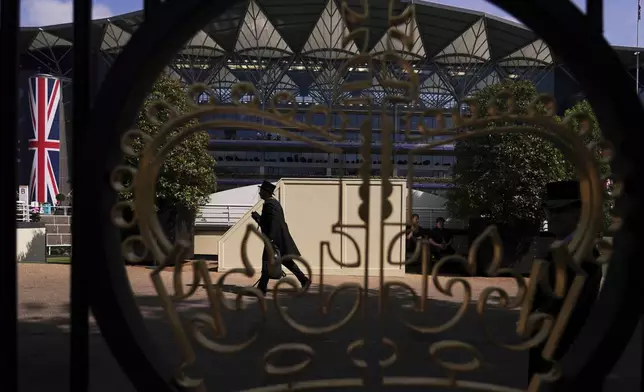 A view of the stands seen through a gold painted crown entrance gate on the second day of the Royal Ascot horse race meeting at Ascot, England, Wednesday June 18, 2025. (AP Photo/Alberto Pezzali) (AP Photo/Alberto Pezzali)