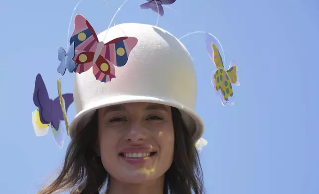 Demean Spucyte smiles as she wear a butterfly themed has on the third day of the Royal Ascot horse race meeting, traditionally called Ladies Day, at Ascot, England, Thursday, June 19, 2025. (AP Photo/kKn Cheung)