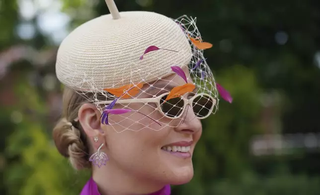 Alexandra Bertram pose for photographers wearing an ornate hat on the first day of the Royal Ascot horse race meeting at Ascot, England, Tuesday, June 17, 2025. (AP Photo/Alberto Pezzali)