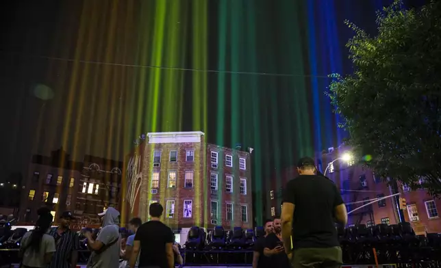 FILE - A rainbow light display illuminates the night sky in the West Village near The Stonewall Inn, birthplace of the gay rights movement, June 27, 2020, in New York. (AP Photo/Bebeto Matthews, File)