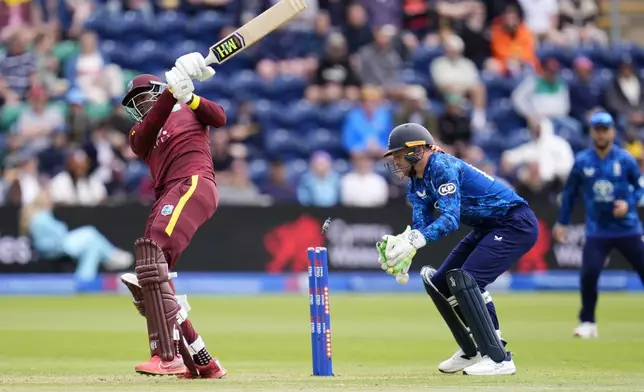 West Indies' Alzarri Joseph, left, is bowled by England's Adil Rashid during the second One Day International cricket match between West Indies and England at Sophia Gardens, Cardiff, Wales, Sunday, June 1, 2025. (Nick Potts/PA via AP)