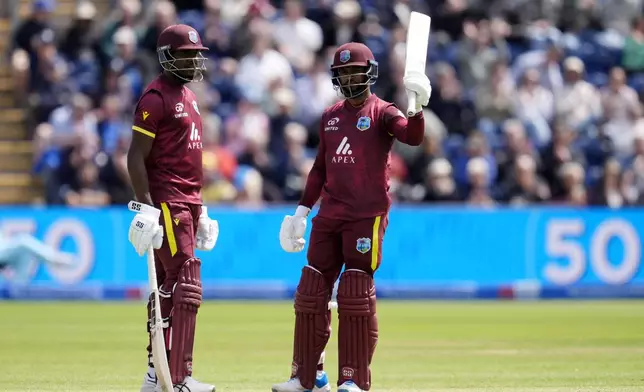 West Indies' Shai Hope, right, celebrates reaching his fifty with Justin Greaves during the second One Day International cricket match between West Indies and England at Sophia Gardens, Cardiff, Wales, Sunday, June 1, 2025. (Nick Potts/PA via AP)