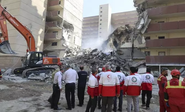 In this photo released by the Iranian Red Crescent Society rescuers work at the scene of an explosion after an Israeli strike in Tehran, Iran, Friday, June 13, 2025. (Iranian Red Crescent Society via AP)