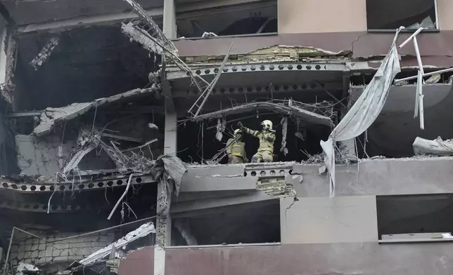 Firefighters work the scene of an explosion at a residence compound in northern Tehran, Iran, Friday, June 13, 2025. (AP Photo/Vahid Salemi)