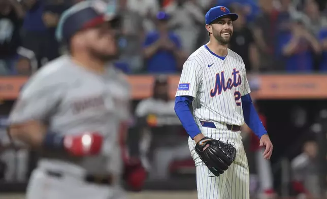 New York Mets' David Peterson, right, smiles as Washington Nationals' Andrés Chaparro, left, grounds out during the ninth inning to end the baseball game Wednesday, June 11, 2025, in New York. (AP Photo/Frank Franklin II)